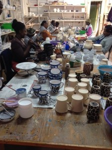 The cups being prepared for their second firing to seal the paintwork.