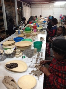 Painting the plates before they go into the kilns.
