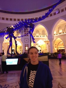 Liz inside the mall, not really interested in the dinosaur.