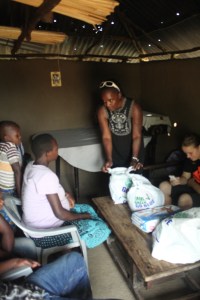 Lindah, our host, showing a soon to be mum how to use the things we had bought her.